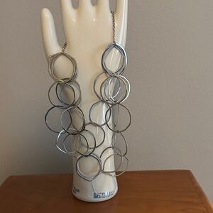 Silver circle layer necklace with adjustable chain.